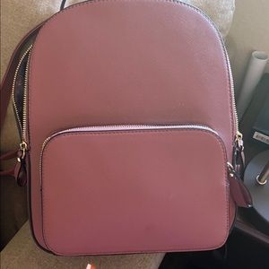 Assorted purses. All different sizes, brands, and colors.